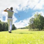 Full length of golf player playing golf