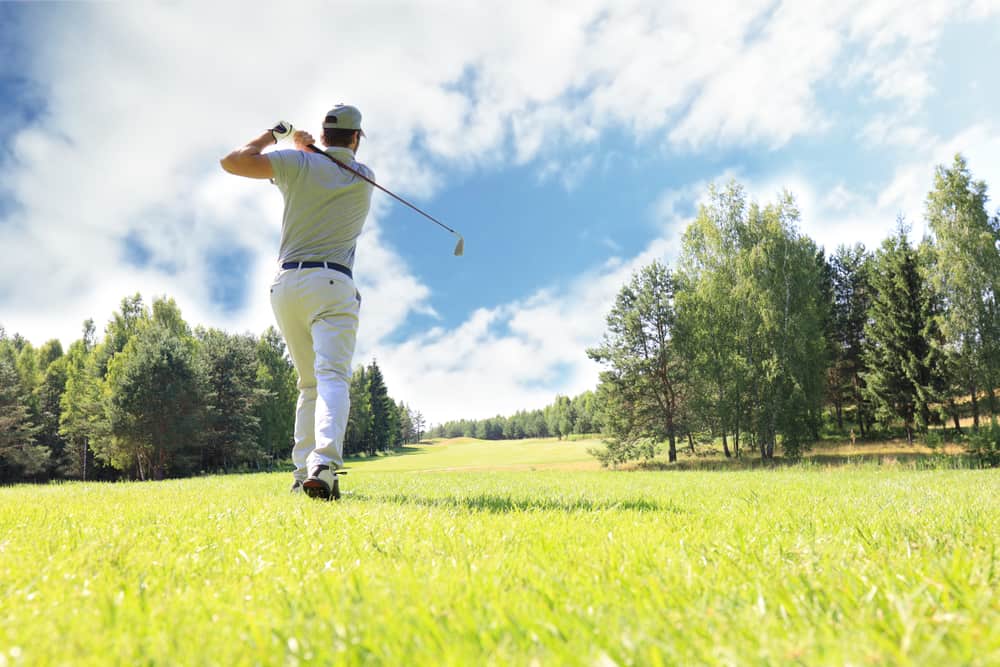 Full length of golf player playing golf