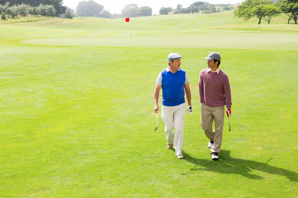 Golfer friends walking and chatting