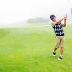 Golfer teeing off