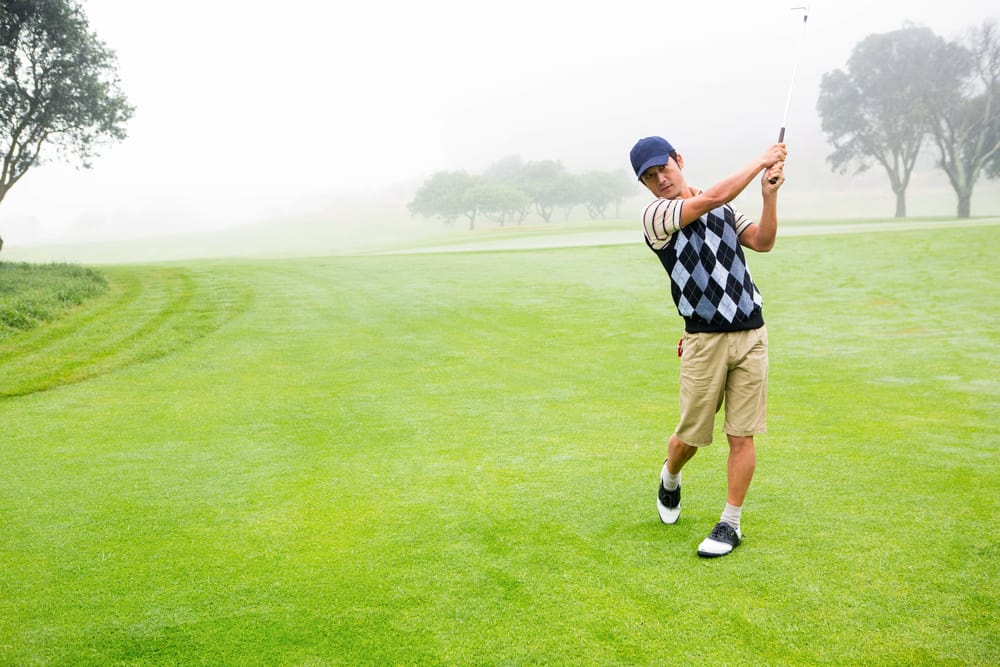 Golfer teeing off