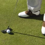 Person Putting Golf Ball