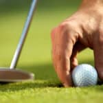 Person holding golf ball