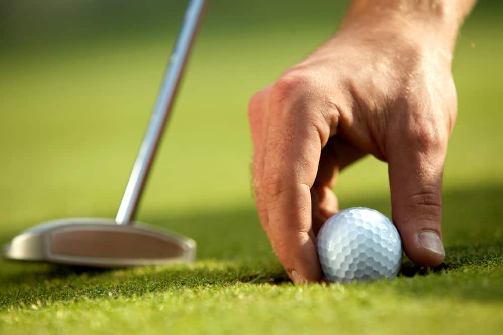 Person holding golf ball