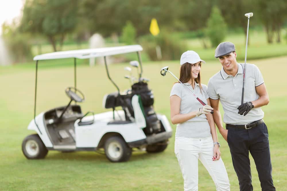 Young couple at golf cart