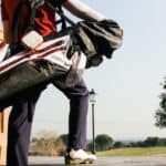 Golfer with his bag entering in a golf course