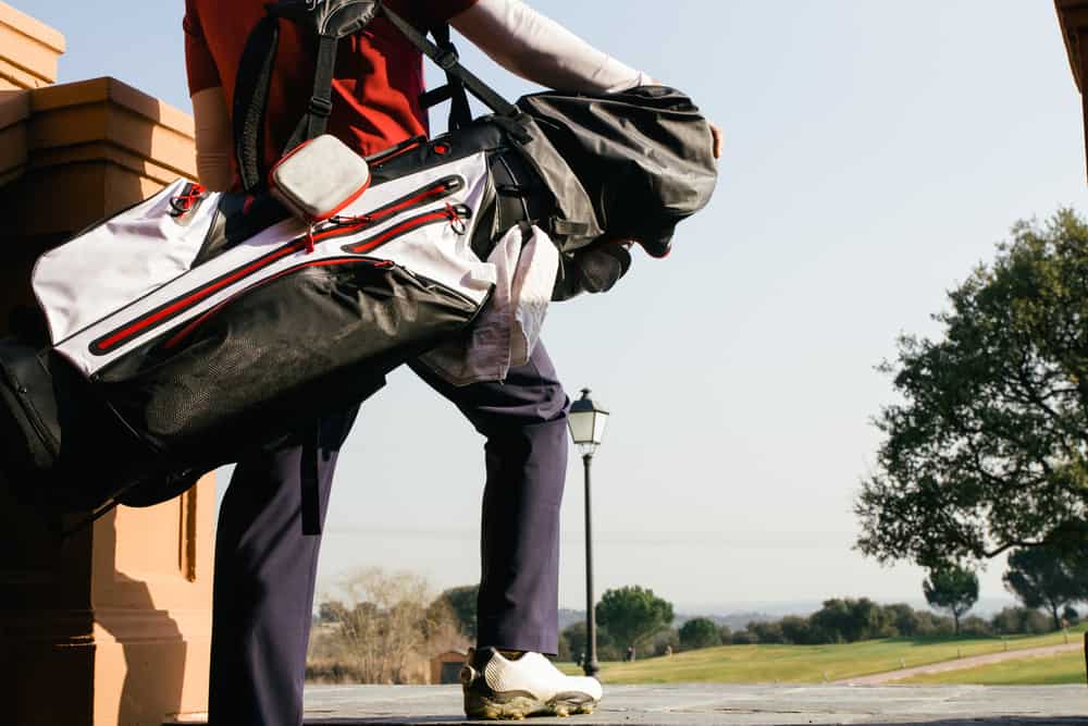 Golfer with his bag entering in a golf course