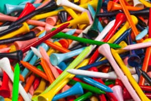 Various wooden golf tees in a box
