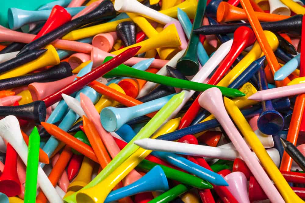 Various wooden golf tees in a box