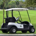 A Golf cart and golf clubs bag