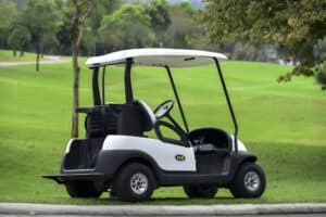 A Golf cart and golf clubs bag