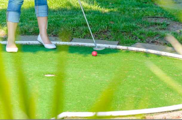 Close-up Mini Golf hole with bat and ball